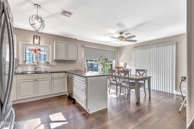 kitchen with a baseboard heating unit, dark hardwood / wood-style flooring, kitchen peninsula, stainless steel fridge, and decorative light fixtures