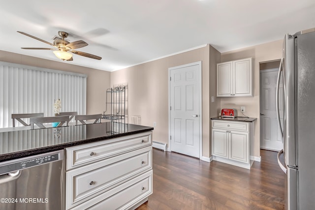 kitchen with appliances with stainless steel finishes, white cabinetry, a baseboard radiator, and dark hardwood / wood-style flooring