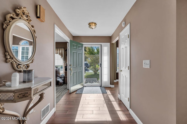 entryway with dark hardwood / wood-style flooring