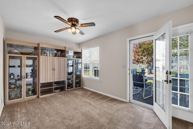 spare room featuring light carpet and ceiling fan