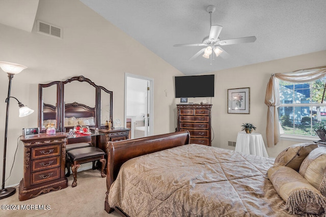 carpeted bedroom featuring ceiling fan, a textured ceiling, lofted ceiling, and ensuite bathroom