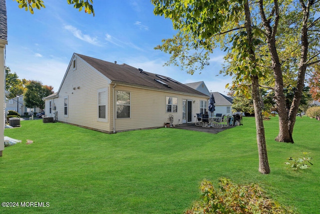 back of house featuring a patio and a lawn