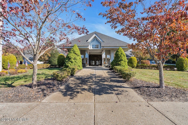 view of front facade with a front yard and a carport