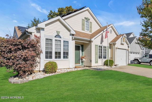 view of property featuring a front lawn and a garage