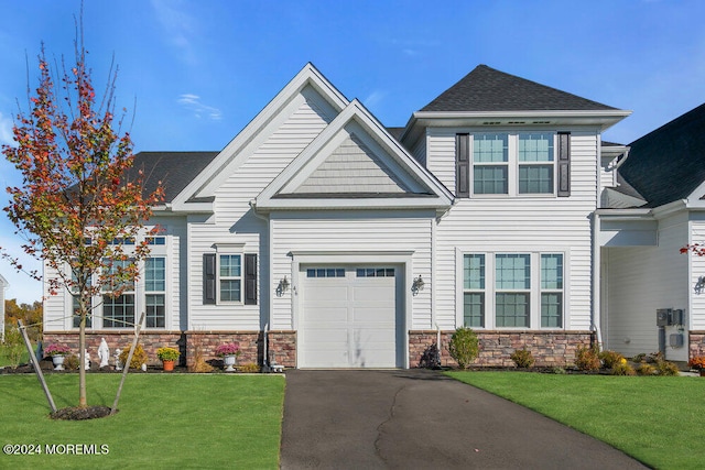 craftsman-style house featuring a front yard and a garage