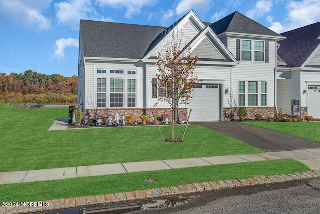 craftsman-style house with a front yard and a garage