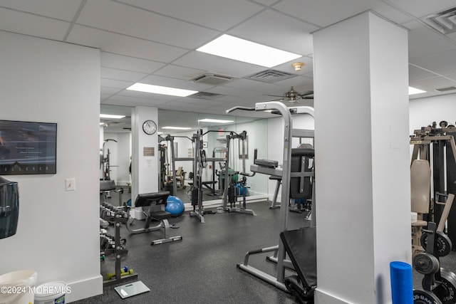 workout area with a drop ceiling and ceiling fan