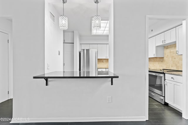 kitchen with white cabinetry, a kitchen breakfast bar, stainless steel appliances, and pendant lighting