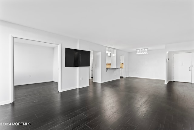 unfurnished living room with dark hardwood / wood-style floors