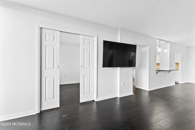 unfurnished living room featuring dark hardwood / wood-style flooring