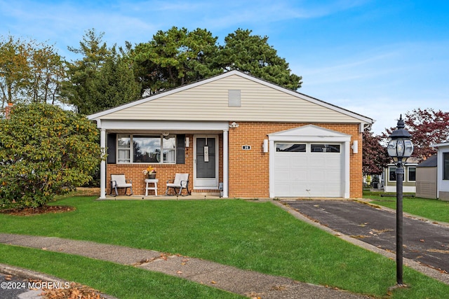 view of front of house featuring a garage and a front lawn