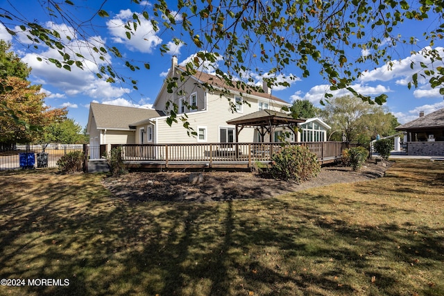 back of property with a yard, a gazebo, and a deck