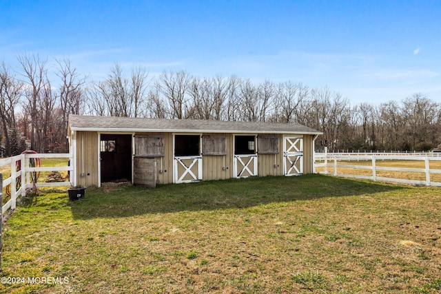 view of outdoor structure featuring a lawn