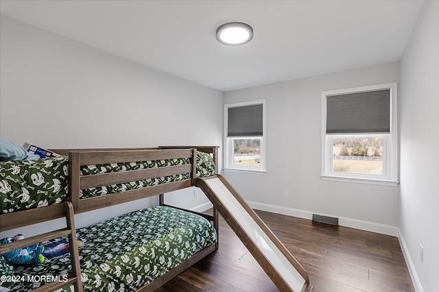 bedroom with dark hardwood / wood-style floors