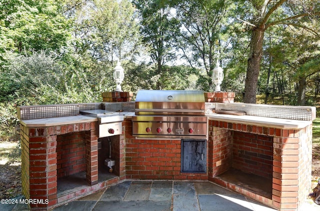 view of patio / terrace featuring area for grilling and an outdoor kitchen