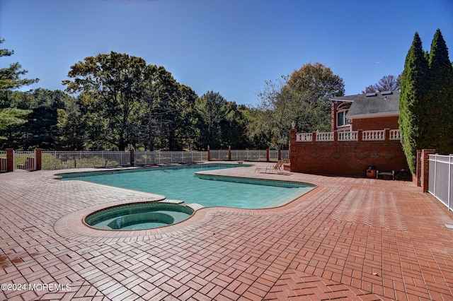 view of pool with an in ground hot tub and a patio