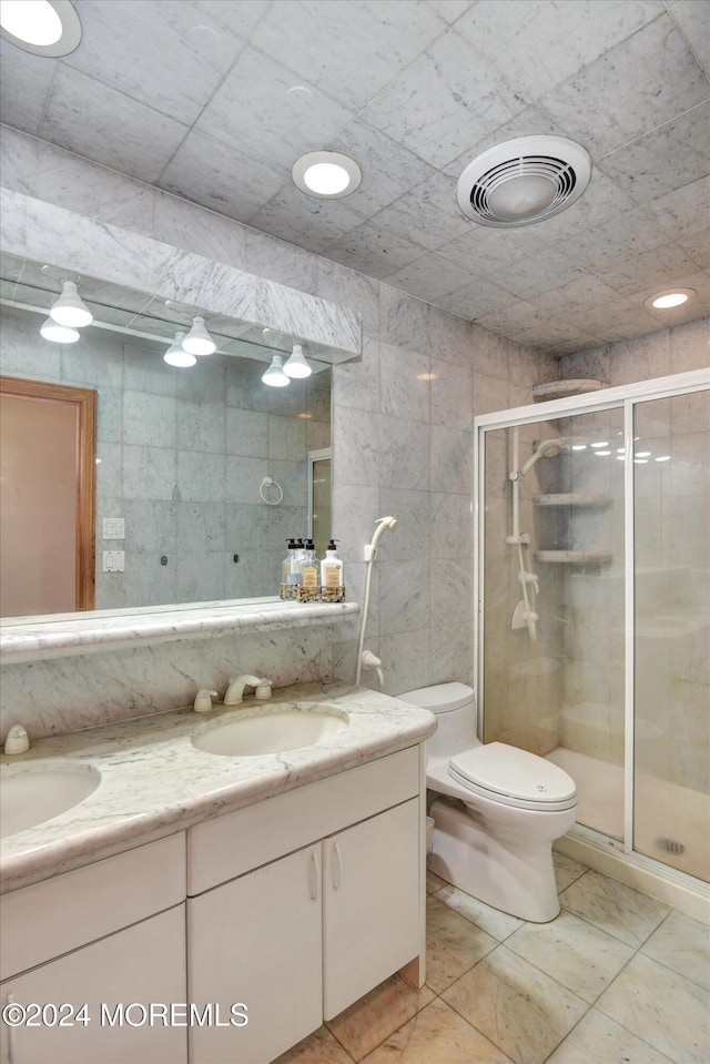 bathroom featuring vanity, toilet, tile patterned floors, and walk in shower