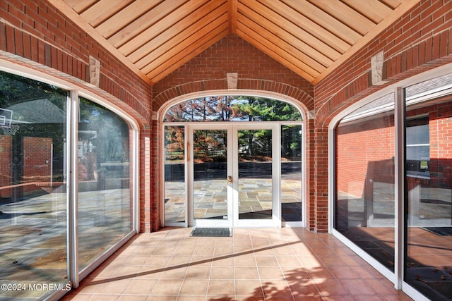 unfurnished sunroom featuring a healthy amount of sunlight and lofted ceiling