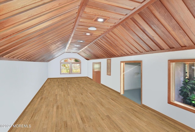 additional living space with wood ceiling, hardwood / wood-style flooring, and vaulted ceiling