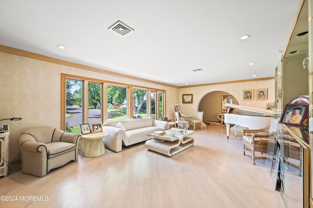 living room with light hardwood / wood-style floors and ornamental molding