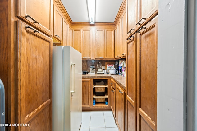 kitchen with decorative backsplash, white fridge, and light tile patterned flooring