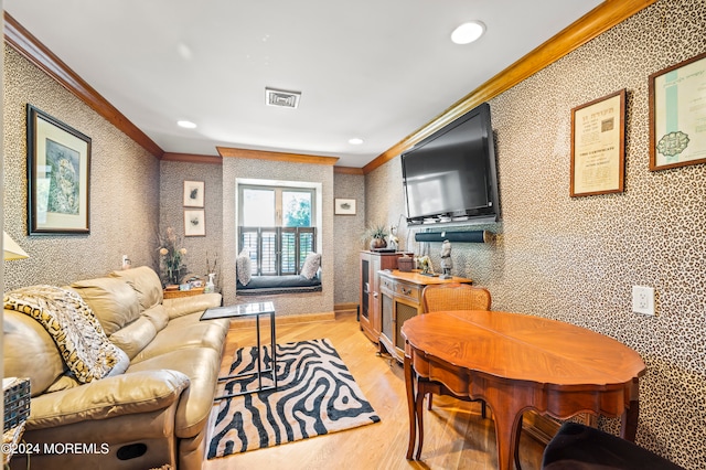 living room with crown molding and light hardwood / wood-style flooring