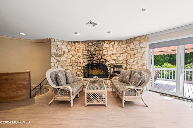 sitting room with light hardwood / wood-style floors, crown molding, and a fireplace