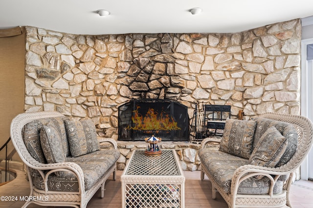 living room featuring wood-type flooring and a fireplace