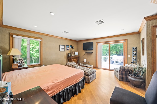 bedroom featuring light hardwood / wood-style flooring, multiple windows, access to exterior, and crown molding