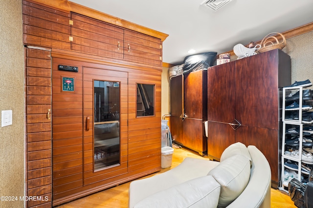 kitchen featuring light hardwood / wood-style floors and wood walls