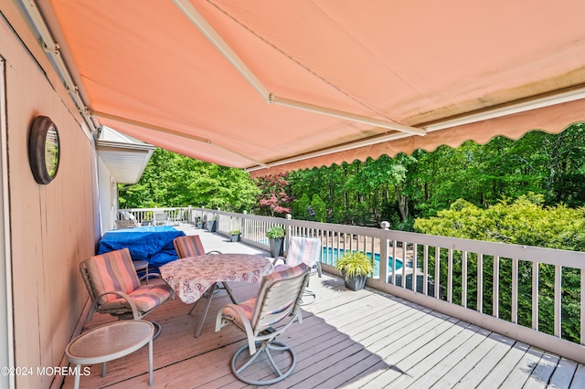 wooden terrace featuring a fenced in pool