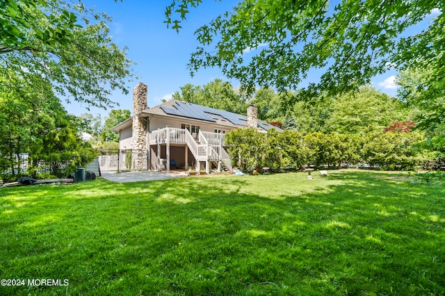 view of yard with a deck and a patio