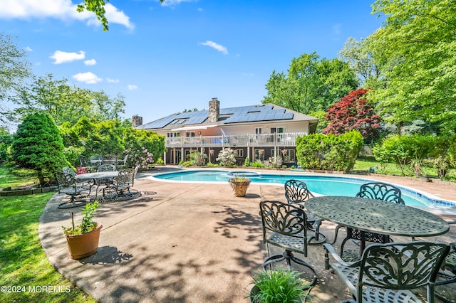 view of pool featuring a patio and a diving board