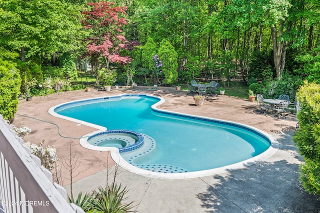 view of pool featuring an in ground hot tub and a patio area