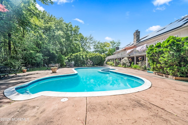 view of swimming pool with a patio area