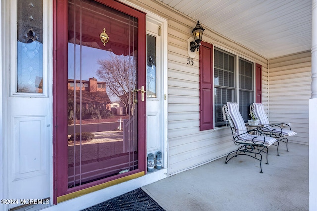 view of exterior entry with a porch