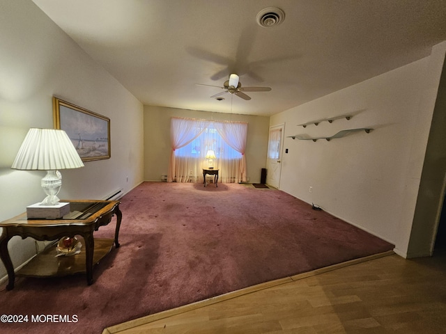 unfurnished room with visible vents, ceiling fan, carpet floors, and a baseboard radiator