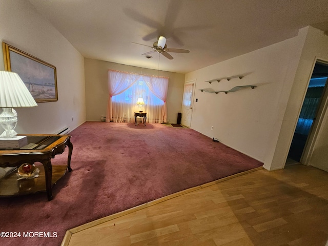 unfurnished room with carpet floors, a baseboard heating unit, and ceiling fan