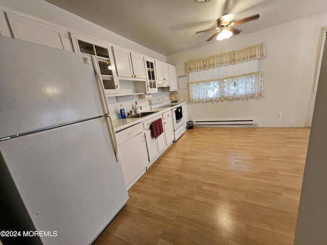 kitchen with a sink, a baseboard heating unit, light wood finished floors, white appliances, and a ceiling fan