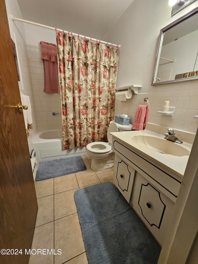 full bathroom featuring tile walls, toilet, vanity, shower / tub combo with curtain, and tile patterned floors