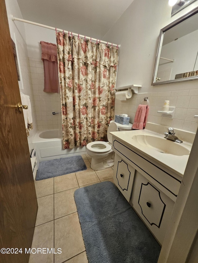 bathroom featuring shower / tub combo with curtain, toilet, tile walls, vanity, and tile patterned flooring