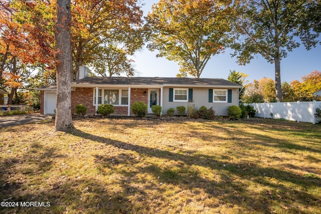 single story home with a front yard and a garage