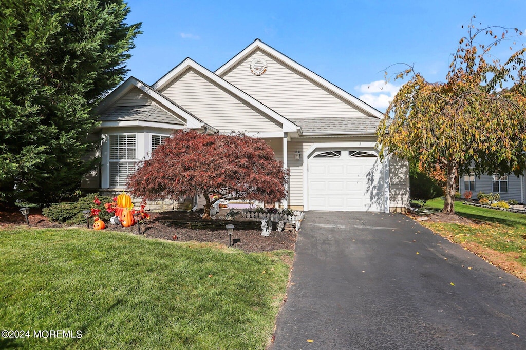 view of front of home featuring a front lawn and a garage