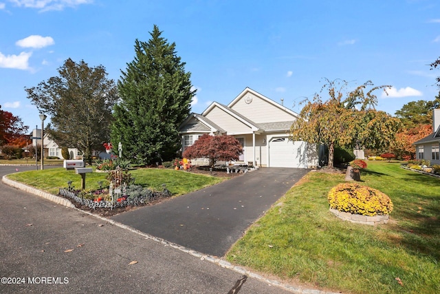 view of front facade with a garage and a front yard