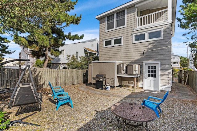 back of property with a balcony