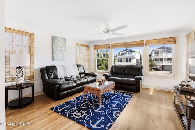 living room featuring hardwood / wood-style floors and ceiling fan