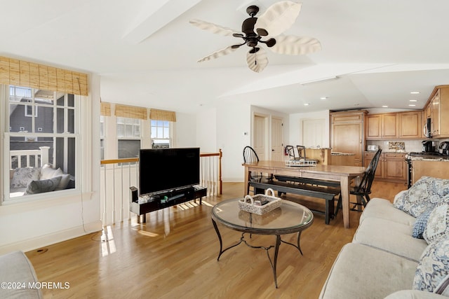 living room featuring light hardwood / wood-style floors and ceiling fan