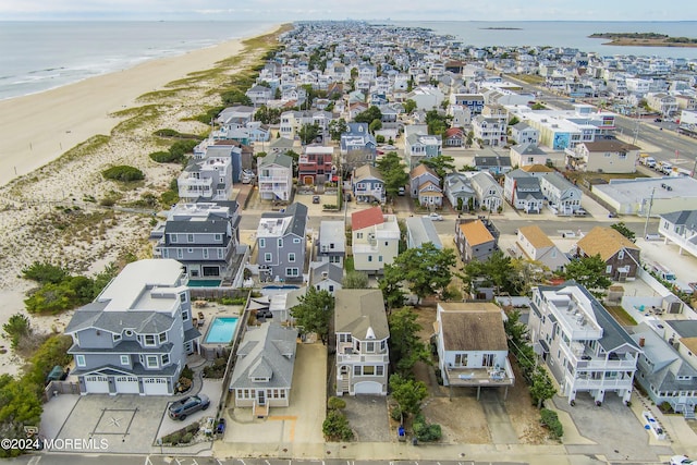 aerial view with a water view and a view of the beach