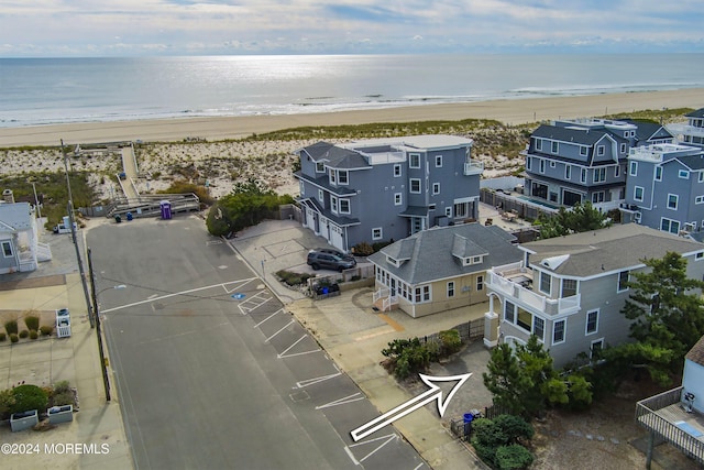 birds eye view of property featuring a water view and a view of the beach