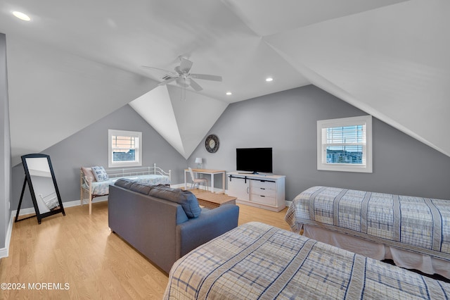 bedroom featuring vaulted ceiling, light hardwood / wood-style flooring, multiple windows, and ceiling fan